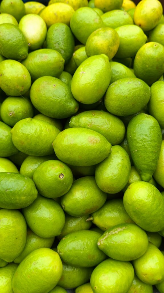 Fresh green limes piled together